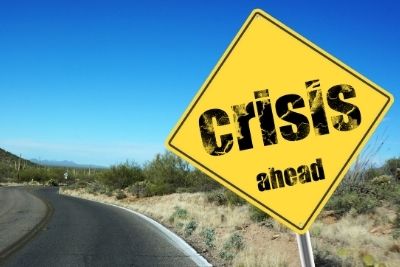 Sign on road saying 'crisis ahead'