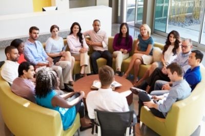 Group of colleagues sat in a circle